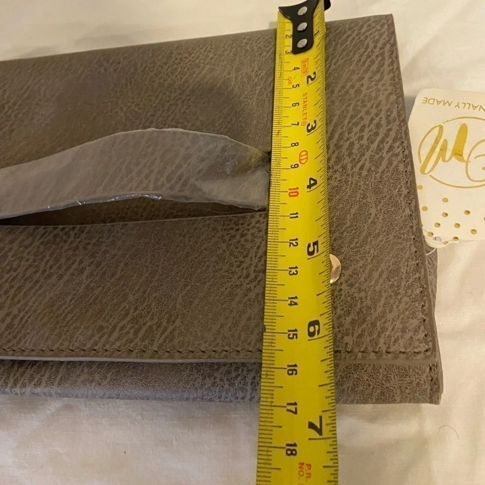 Occasionally made clutch Metallic Leather hand clutch. 9” wide 6” tall new